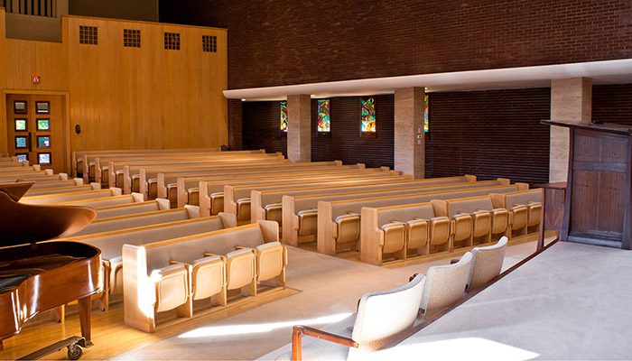 A view of a synagogue's combination seating from the front of the hall.