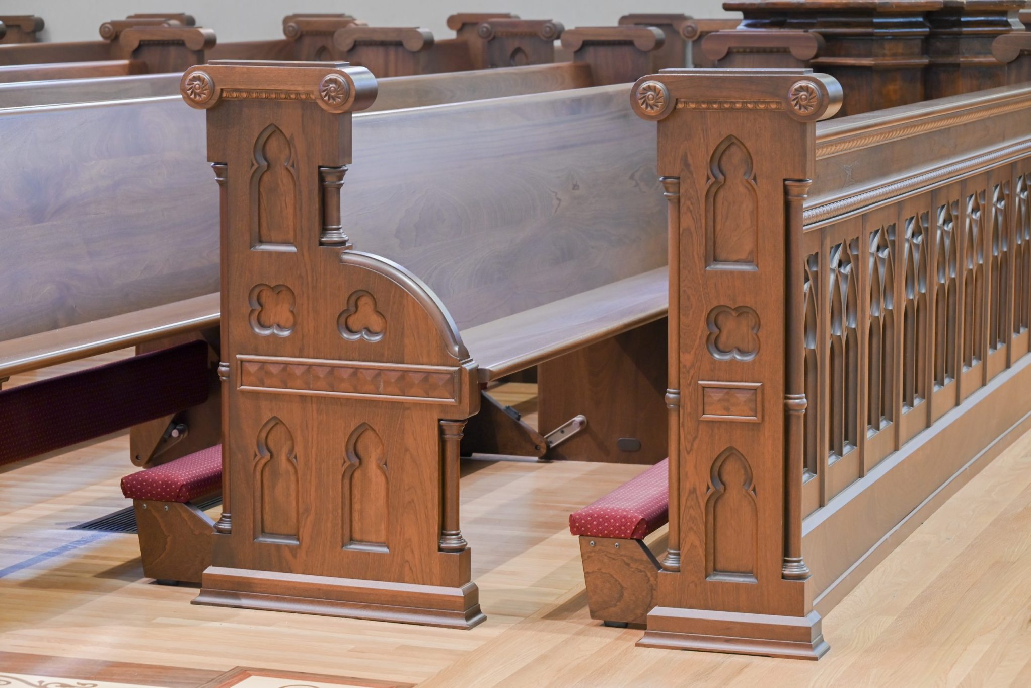 Pew end panels with decorative designs.